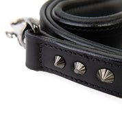 Black leather strap with silver studs on a white background