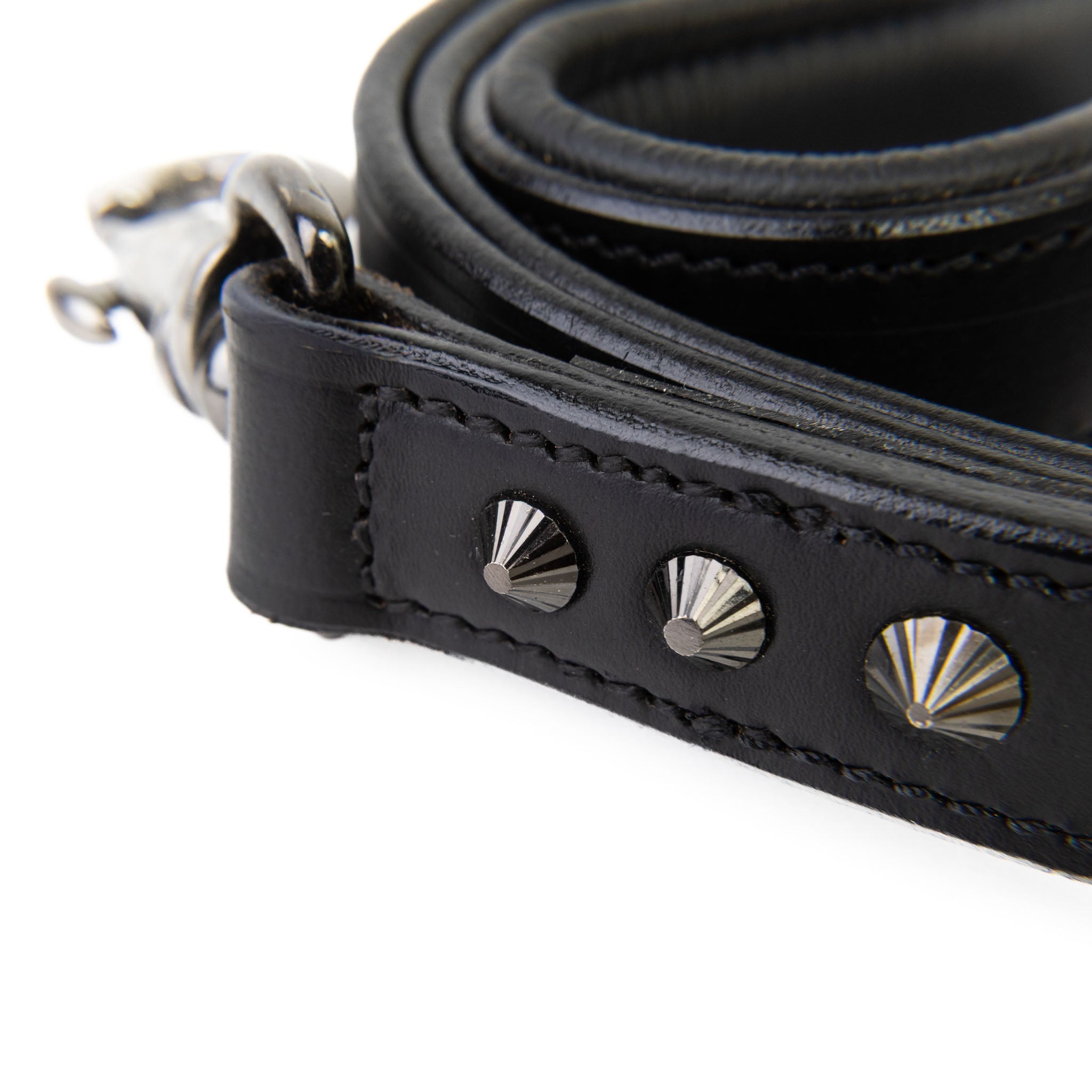 Black leather strap with silver studs on a white background