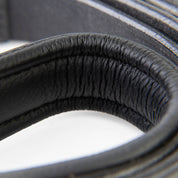 Close-up of a black earbud with a blurred background